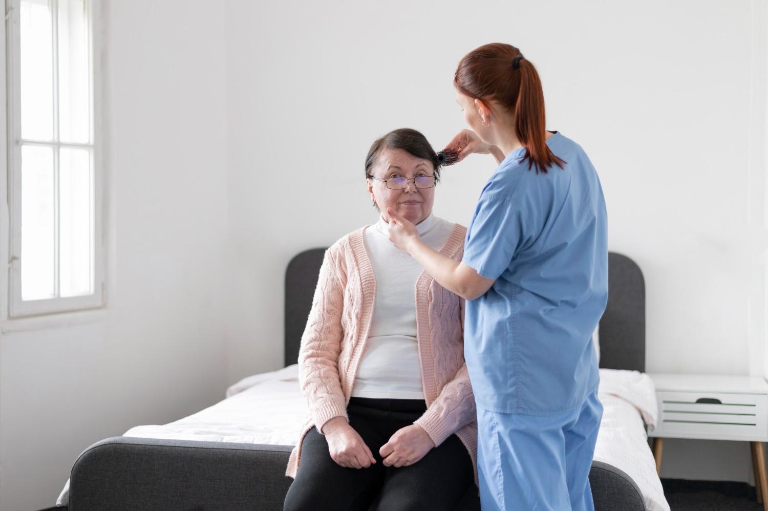 Caregiver assisting a senior patient at home after surgery